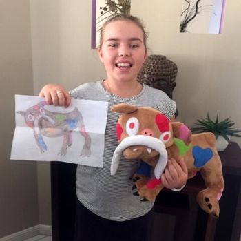 Happy kid with Child's Own personalized plushie